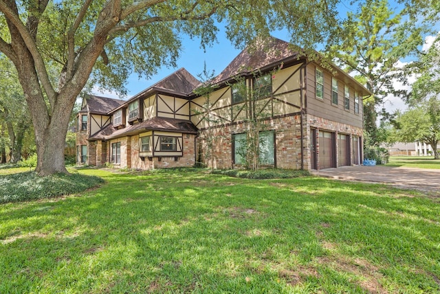 7527 Cart Gate Dr, Houston, TX 77095 - view of front of home with a garage, concrete driveway, brick siding, and a front lawn
