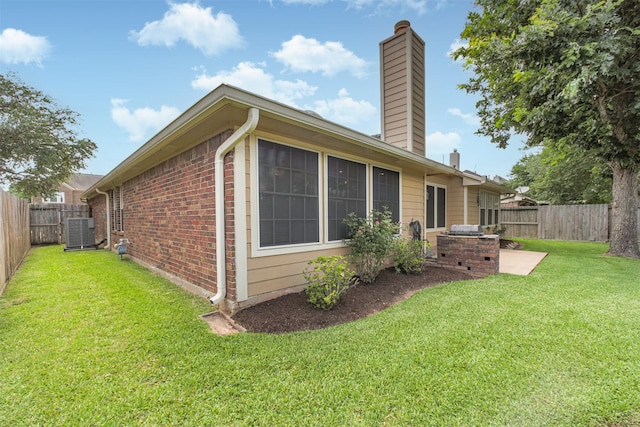 2001 Navajo Dr, Deer Park, TX 77536 - view of property exterior with a chimney, brick siding, a fenced backyard, and a patio