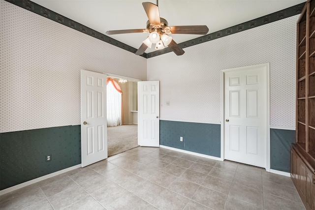 2001 Navajo Dr, Deer Park, TX 77536 - tiled spare room featuring wallpapered walls and ceiling fan