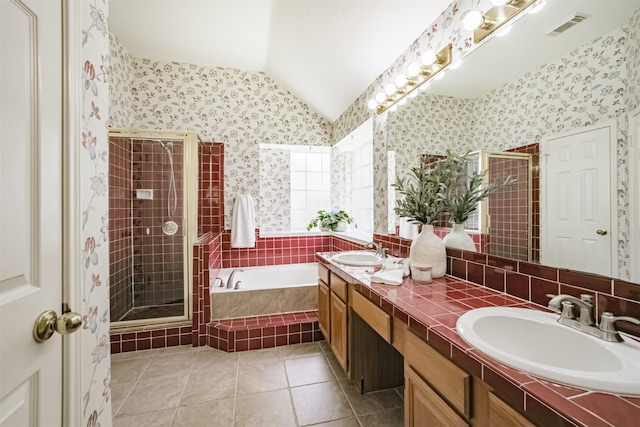 2001 Navajo Dr, Deer Park, TX 77536 - full bath with double vanity, a bath, a shower stall, lofted ceiling, and tile patterned floors