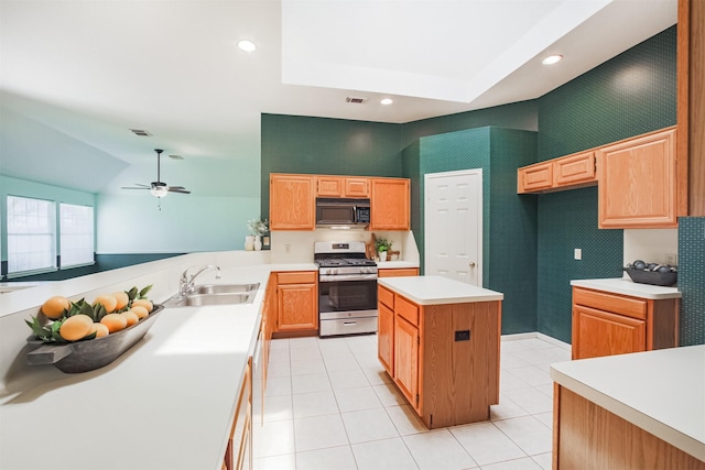 2001 Navajo Dr, Deer Park, TX 77536 - kitchen with gas range, black microwave, light countertops, light tile patterned floors, and ceiling fan