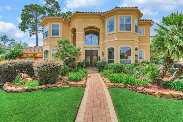 9814 Cape Breeze Dr, Houston, TX 77070 - mediterranean / spanish-style home featuring french doors, a front yard, stucco siding, and a tile roof