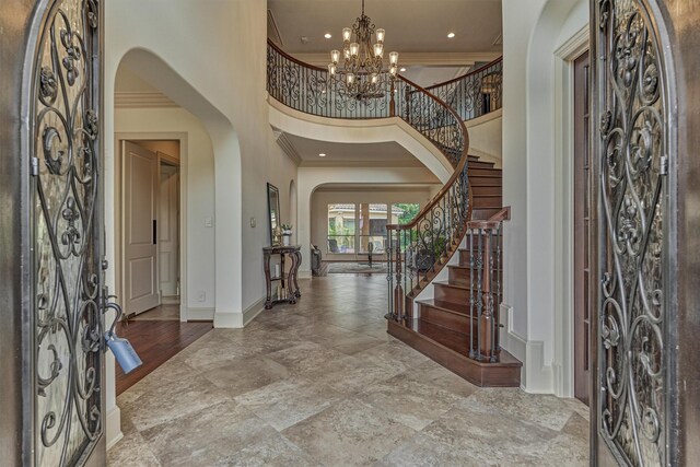9814 Cape Breeze Dr, Houston, TX 77070 - foyer with arched walkways, ornamental molding, a towering ceiling, baseboards, and stairway