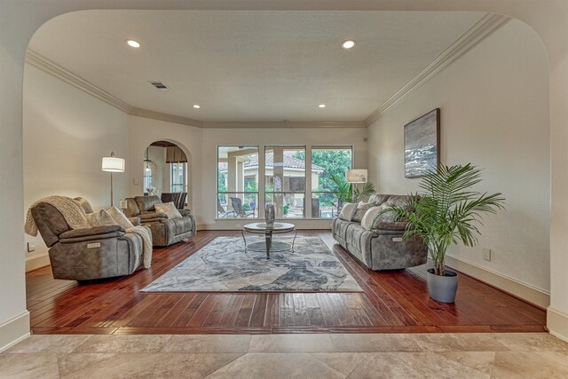9814 Cape Breeze Dr, Houston, TX 77070 - living room with arched walkways, baseboards, ornamental molding, hardwood / wood-style floors, and recessed lighting