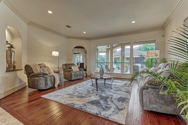 9814 Cape Breeze Dr, Houston, TX 77070 - living area with arched walkways, dark wood finished floors, ornamental molding, recessed lighting, and baseboards