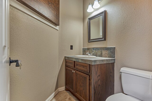 9814 Cape Breeze Dr, Houston, TX 77070 - bathroom with vanity, toilet, and a textured wall