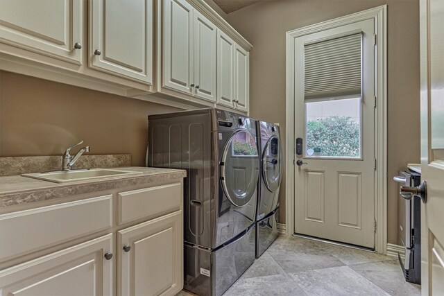 9814 Cape Breeze Dr, Houston, TX 77070 - laundry room featuring independent washer and dryer and cabinet space