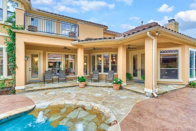 9814 Cape Breeze Dr, Houston, TX 77070 - back of property with french doors, a ceiling fan, a balcony, a patio area, and a chimney