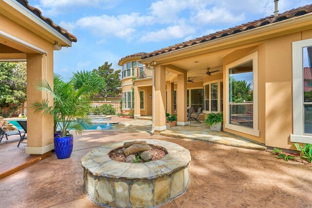 9814 Cape Breeze Dr, Houston, TX 77070 - view of patio featuring a fire pit, a ceiling fan, and a pool with connected hot tub