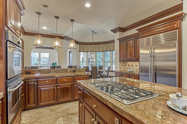 9814 Cape Breeze Dr, Houston, TX 77070 - kitchen featuring stainless steel appliances, arched walkways, ornamental molding, healthy amount of natural light, and pendant lighting
