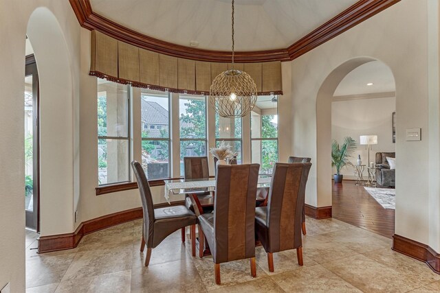 9814 Cape Breeze Dr, Houston, TX 77070 - dining space featuring ornamental molding, arched walkways, baseboards, and a chandelier