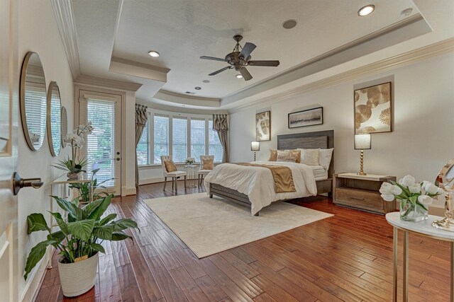 9814 Cape Breeze Dr, Houston, TX 77070 - bedroom with a tray ceiling, access to exterior, crown molding, hardwood / wood-style floors, and recessed lighting