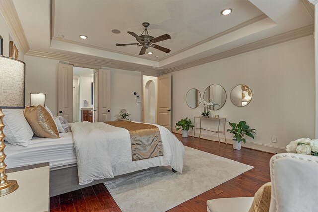 9814 Cape Breeze Dr, Houston, TX 77070 - bedroom with a tray ceiling, arched walkways, hardwood / wood-style floors, crown molding, and recessed lighting