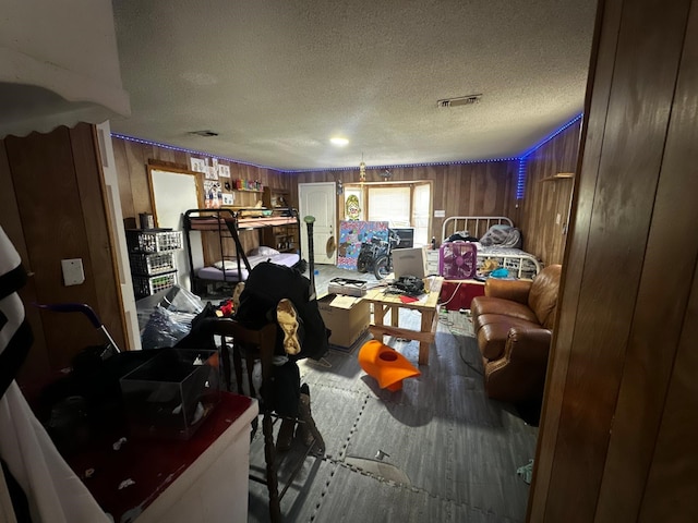 1225 County Road 878b, Sweeny, TX 77480 - living room with a textured ceiling, wooden walls, and wood finished floors
