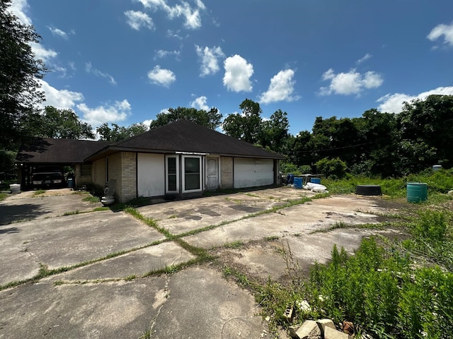 1225 County Road 878b, Sweeny, TX 77480 - view of property exterior featuring brick siding, concrete driveway, and an attached garage