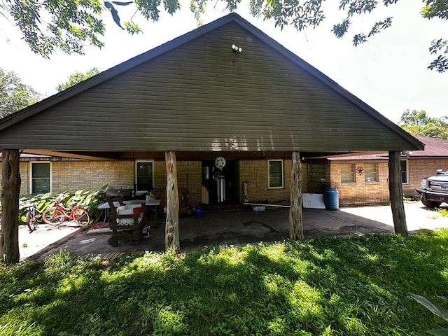 1225 County Road 878b, Sweeny, TX 77480 - rear view of property with a patio area and brick siding