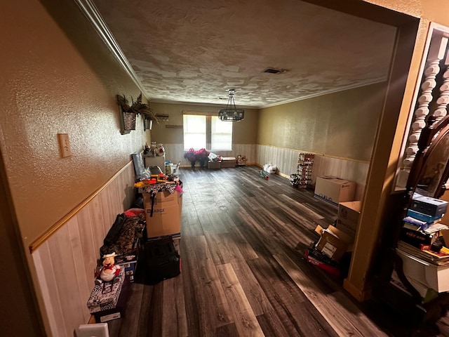 1225 County Road 878b, Sweeny, TX 77480 - misc room featuring wainscoting, crown molding, dark wood-style flooring, and a textured wall