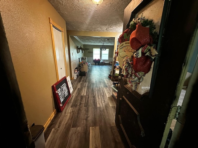 1225 County Road 878b, Sweeny, TX 77480 - hallway featuring a textured ceiling, a textured wall, dark wood finished floors, and baseboards