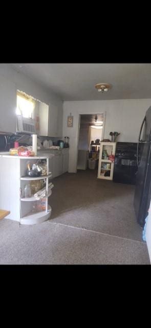 209 W Alfred St W, El Campo, TX 77437 - kitchen with freestanding refrigerator and carpet floors