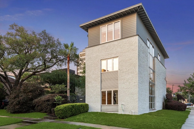 2327 Peckham St, Houston, TX 77019 - view of side of home featuring brick siding and a lawn