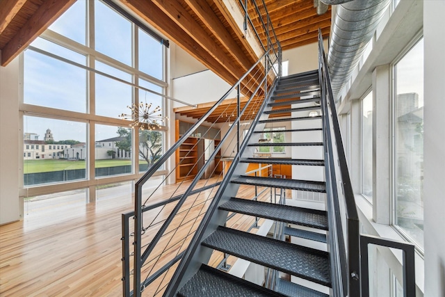 2327 Peckham St, Houston, TX 77019 - stairs featuring wood finished floors, healthy amount of natural light, a chandelier, and a towering ceiling