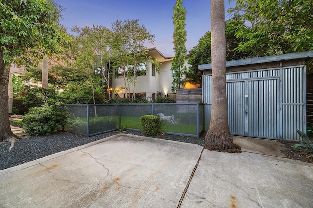 2327 Peckham St, Houston, TX 77019 - gate at dusk with a patio and a storage unit