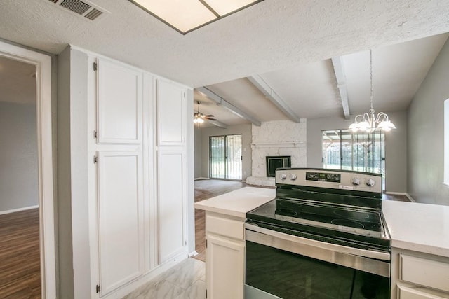 14918 Silver Green Dr S, Channelview, TX 77530 - kitchen featuring stainless steel range with electric cooktop, light countertops, a stone fireplace, a textured ceiling, and ceiling fan