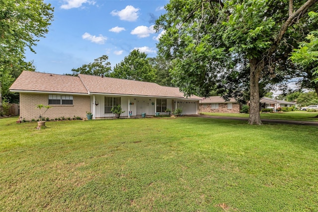 410 Azalea Dr, Baytown, TX 77520 - ranch-style house with an attached garage, a porch, a front lawn, brick siding, and driveway