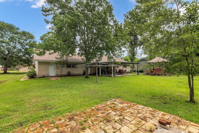 410 Azalea Dr, Baytown, TX 77520 - view of grassy yard with a patio