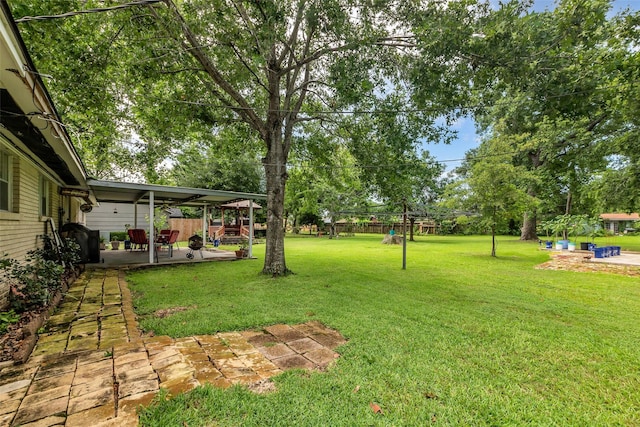 410 Azalea Dr, Baytown, TX 77520 - view of green lawn featuring a patio area and view of scattered trees