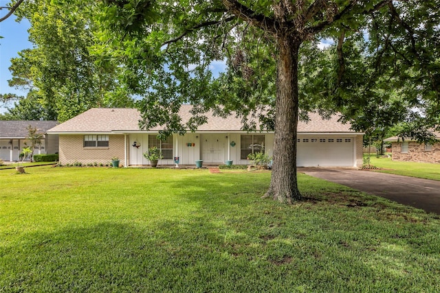 410 Azalea Dr, Baytown, TX 77520 - ranch-style house with driveway, a front lawn, an attached garage, brick siding, and a shingled roof