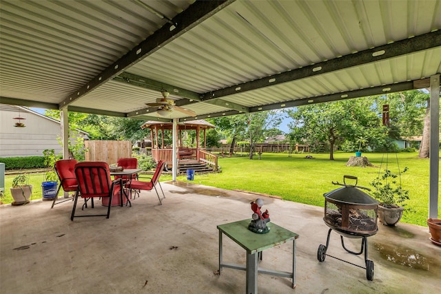 410 Azalea Dr, Baytown, TX 77520 - fenced backyard with a patio area, a ceiling fan, outdoor dining space, and a gazebo