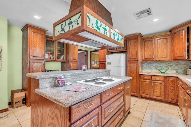 410 Azalea Dr, Baytown, TX 77520 - kitchen with white appliances, light tile patterned floors, brown cabinetry, and recessed lighting
