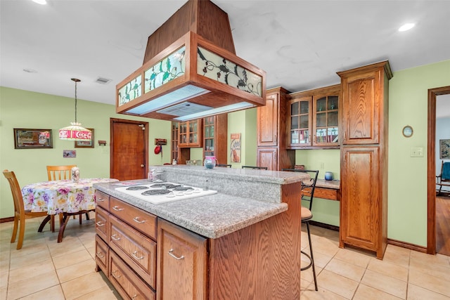 410 Azalea Dr, Baytown, TX 77520 - kitchen featuring light tile patterned flooring, a breakfast bar, a kitchen island, glass insert cabinets, and recessed lighting