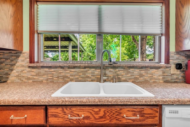 410 Azalea Dr, Baytown, TX 77520 - kitchen with white dishwasher, decorative backsplash, light countertops, and healthy amount of natural light