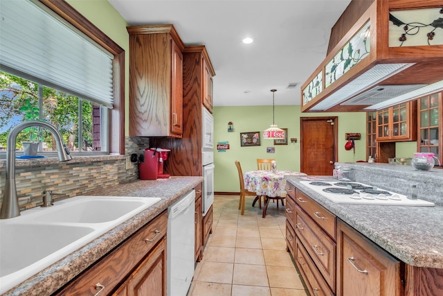 410 Azalea Dr, Baytown, TX 77520 - kitchen featuring white appliances, brown cabinetry, backsplash, pendant lighting, and recessed lighting