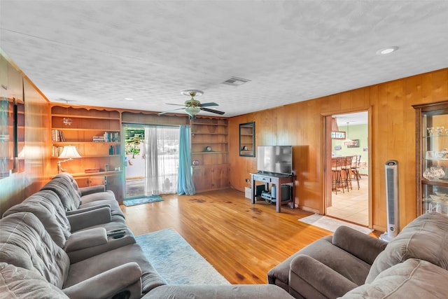 410 Azalea Dr, Baytown, TX 77520 - living room featuring wood walls, ceiling fan, wood finished floors, and recessed lighting