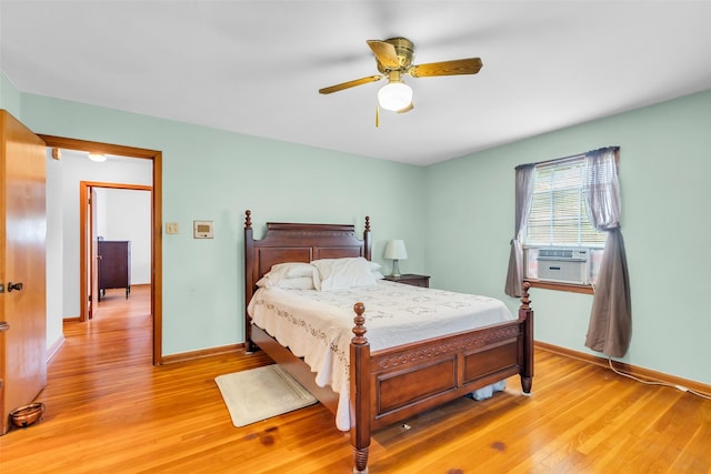 410 Azalea Dr, Baytown, TX 77520 - bedroom with light wood-type flooring, a ceiling fan, and cooling unit