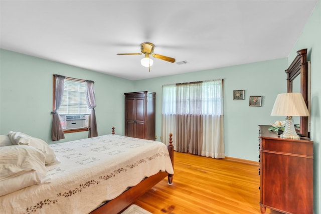 410 Azalea Dr, Baytown, TX 77520 - bedroom with cooling unit, multiple windows, light wood-style flooring, and ceiling fan