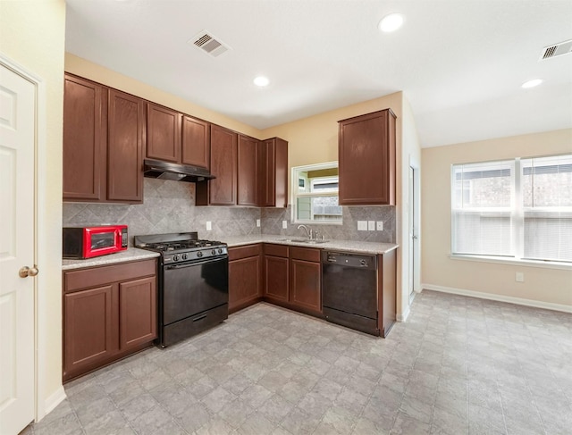 20611 Footstep Path, Katy, TX 77449 - kitchen featuring black appliances, under cabinet range hood, a sink, light countertops, and decorative backsplash