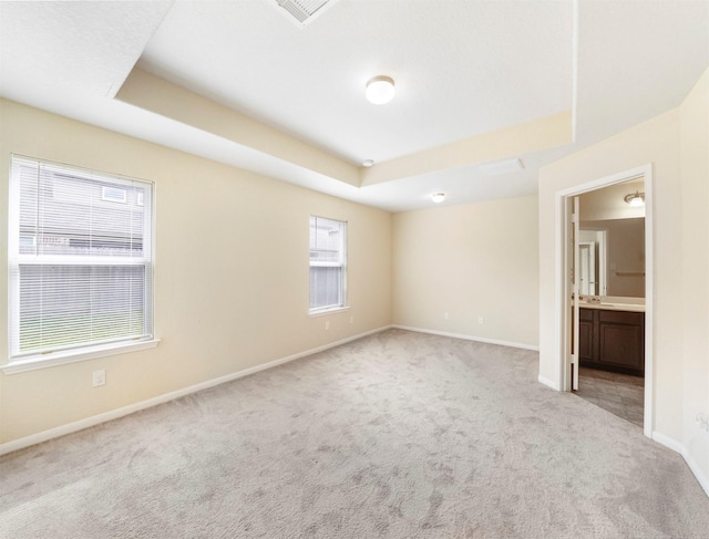 20611 Footstep Path, Katy, TX 77449 - unfurnished bedroom with carpet flooring, baseboards, a raised ceiling, and ensuite bathroom