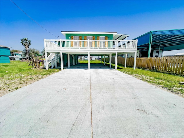 1032 N Selwyn Rd, Crystal Beach, TX 77650 - coastal home featuring concrete driveway, a carport, and stairway