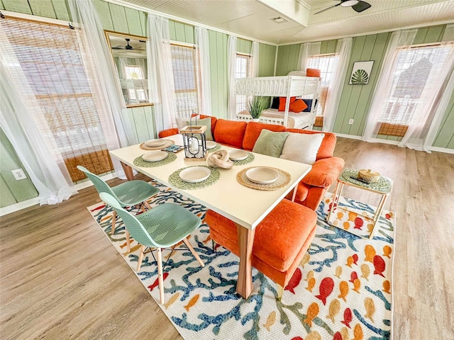 1032 N Selwyn Rd, Crystal Beach, TX 77650 - dining room with wood finished floors, a ceiling fan, crown molding, and baseboards
