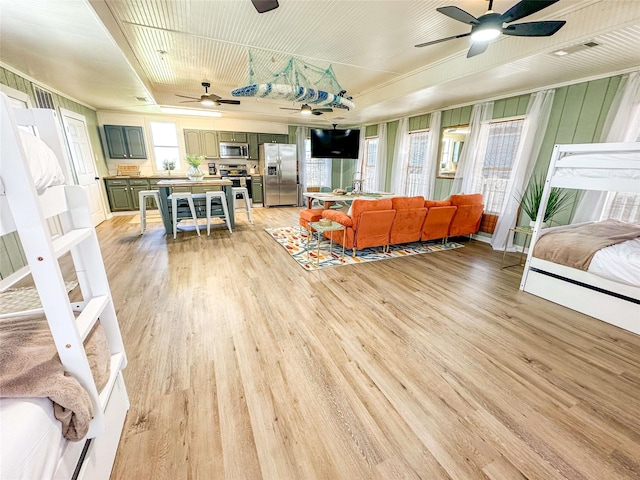 1032 N Selwyn Rd, Crystal Beach, TX 77650 - living area featuring ceiling fan and light wood-style floors