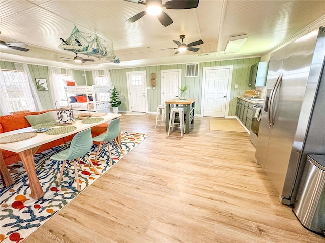 1032 N Selwyn Rd, Crystal Beach, TX 77650 - dining space featuring a ceiling fan, light wood-style floors, and plenty of natural light