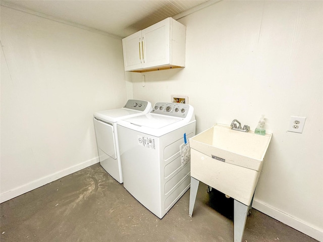 1032 N Selwyn Rd, Crystal Beach, TX 77650 - washroom with cabinet space, washing machine and clothes dryer, and baseboards