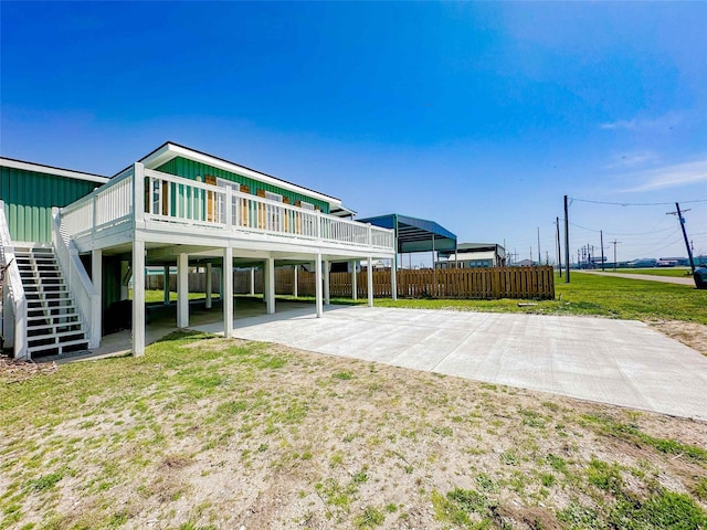 1032 N Selwyn Rd, Crystal Beach, TX 77650 - back of property with stairway and a wooden deck