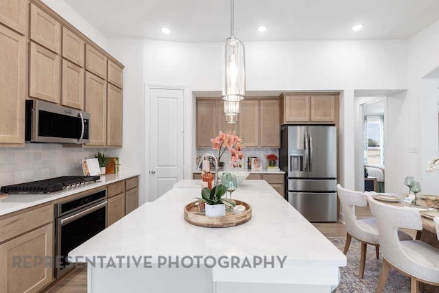 27019 Golden Isle Ln, Katy, TX 77493 - kitchen with appliances with stainless steel finishes, backsplash, a kitchen island, hanging light fixtures, and recessed lighting