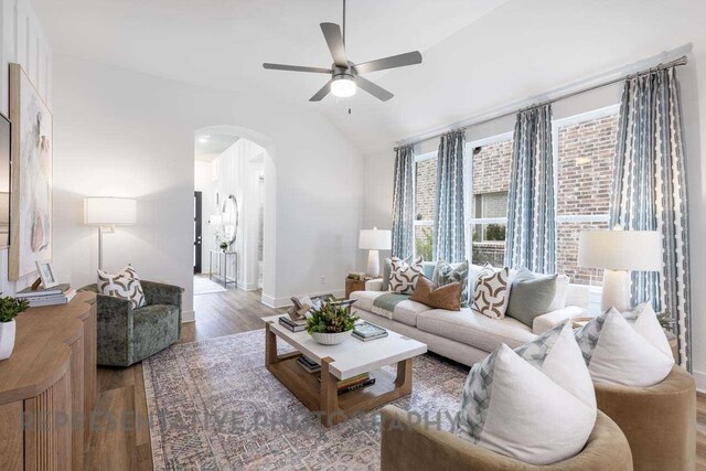 27019 Golden Isle Ln, Katy, TX 77493 - living room with arched walkways, a ceiling fan, wood finished floors, vaulted ceiling, and baseboards