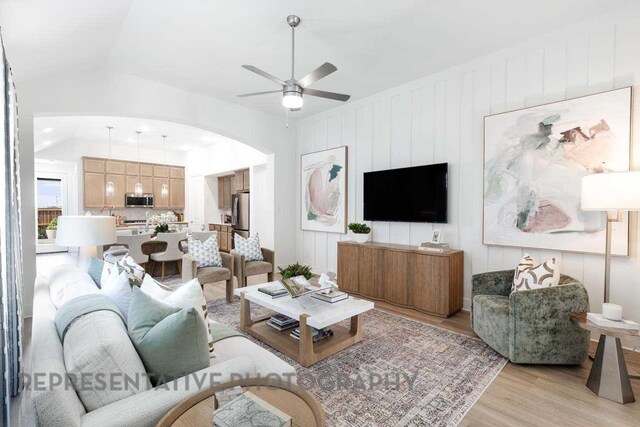 27019 Golden Isle Ln, Katy, TX 77493 - living room with light wood-style floors, arched walkways, and a ceiling fan